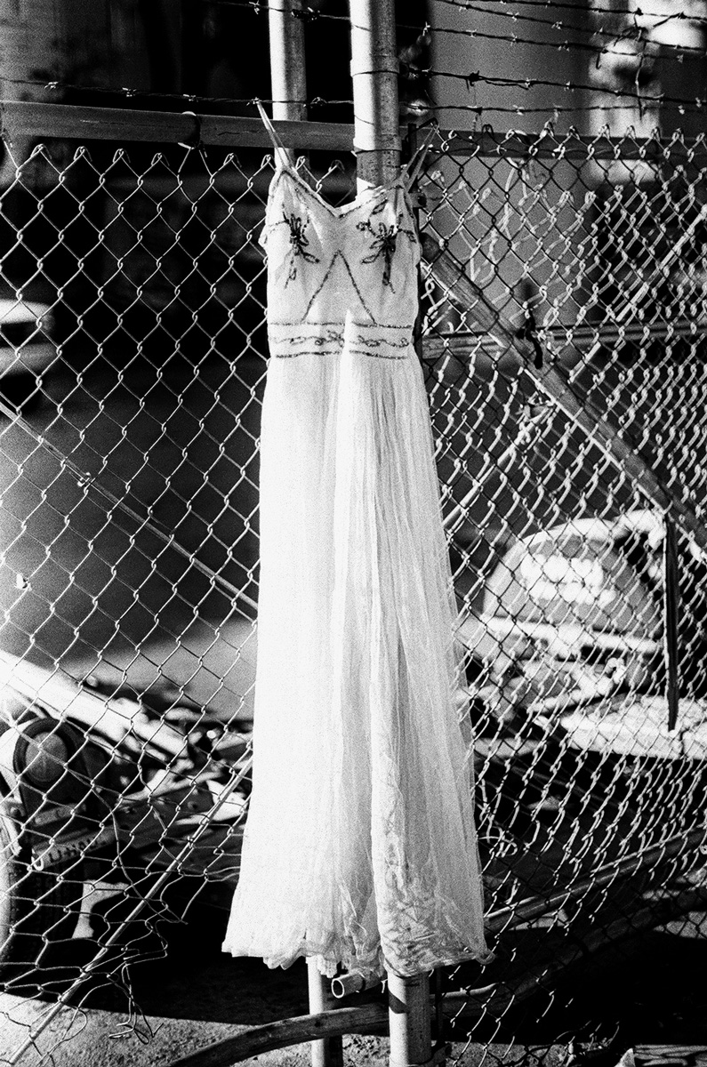 dress on fence street life photograph by Victor Arimondi