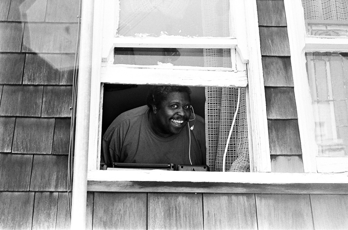man in window street life photograph by Victor Arimondi