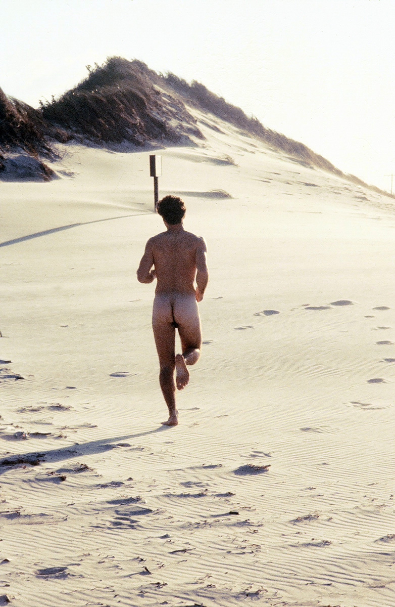 man running on beach photograph by Victor Arimondi